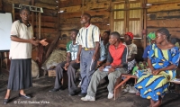 A CARE staff member leading a training session for community volunteers in the DRC on how to raise awareness and respond to gender-based violence