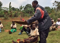 A man taking on a task traditionally undertaken by women during an 'Enlighten' group meeting