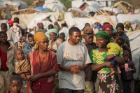 CARE DRC Food Security Manager, Joseph Kakuru, talks with displaced people in Rubaya Camp, DRC. &copy; CARE / Jake Lyell 2013 