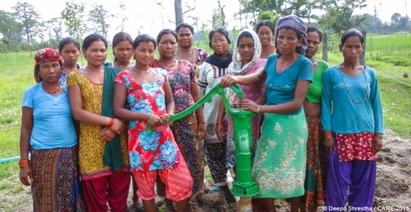 Pragatiseel CLAC women standing in front of hand pump constructed by saving lunch allowance provided to them during CLAC classes ran by the Hariyo Ban Program, CARE Nepal