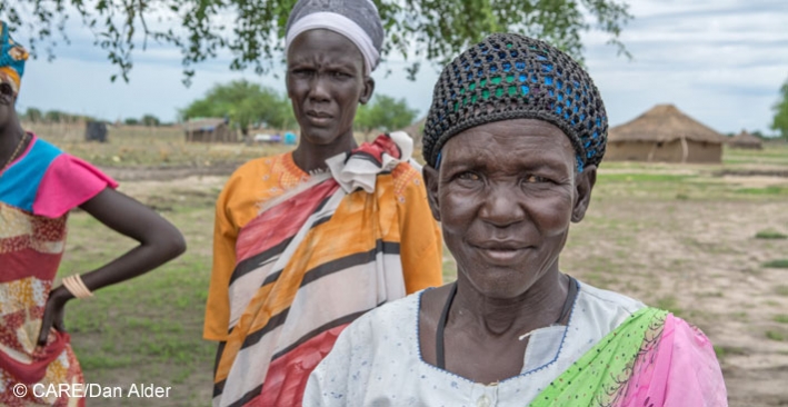 Aluat Deng Gach, widow and mother of 7, arriving at a meeting about a CARE livelihoods project in her village in Jonglei State