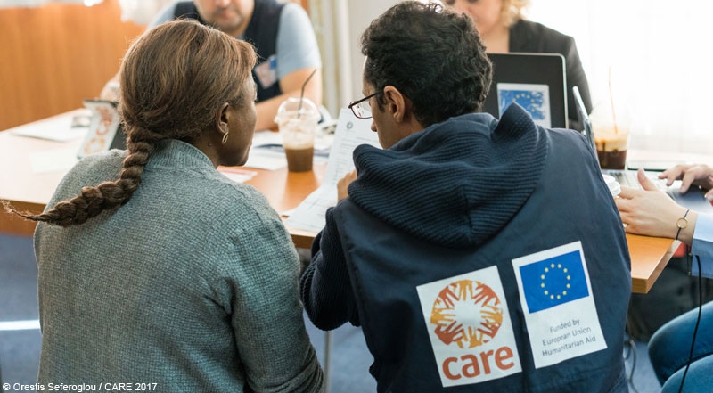 A woman refugee talking to a CARE staff member at an ECHO-funded advice and information project in Greece