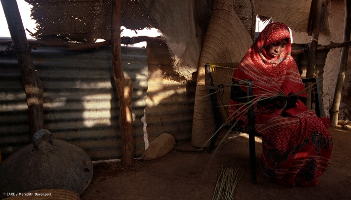 An Eritrean woman weaves grass baskets