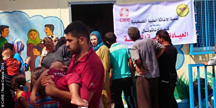 People waiting outside a mobile health clinic set up by CARE and local partner organisation Palestinian Medical Relief Society (PMRS) at a primary school in Gaza city, August 2014