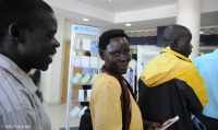 Queuing to make a deposit at a bank in Uganda