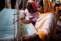 Women work a loom in Bangladesh. &copy;  CARE / Josh Estey 2008 