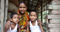 Nargis Pavin, who worked in a factory in India, with two of her children in Botospur, Bangladesh