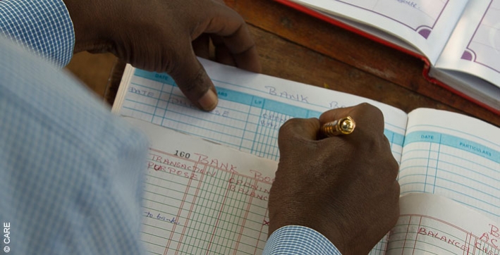 Record-keeping at the weekly meeting of the Village Savings and Loan group in Kawete, Uganda
