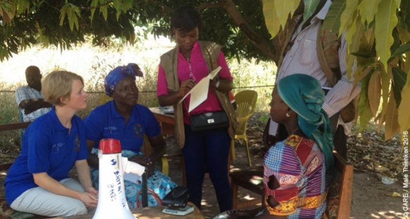  CARE staff interviewing a recipient to ensure transparency in distributing cash payments to displaced people returning to Chad