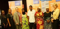 VSLA members, NMB and CARE staff pose for the press at the Pamoja Account launch in Dar es Salaam, Tanzania