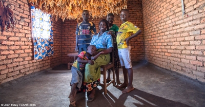 Makulata, a member of the local VSLA, with her family in their home in Lilongwe District, Malawi.
