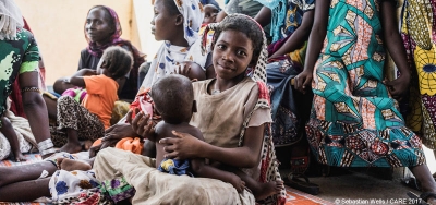 A girl and her sister wait for food supplements at a CARE-run health centre in Chad