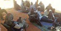 A field supervisor collecting data from a community in Niger using a tablet computer