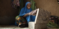 Haoua from Kagadama village near Maradi, Niger, with a VSLA lockbox