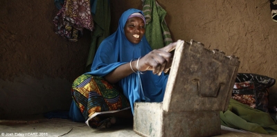 Haoua from Kagadama village near Maradi, Niger, with a VSLA lockbox