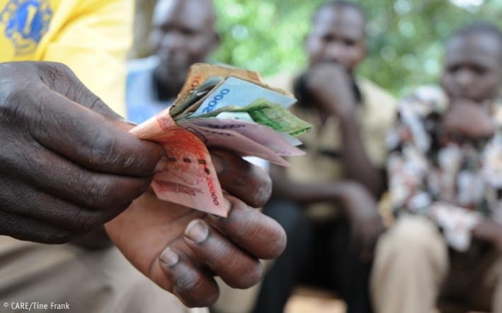 Counting money at a VSLA meeting in Uganda