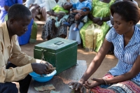A village savings and loans group in Uganda collecting their weekly savings